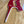 Load image into Gallery viewer, A red and white fish handling device shaped like an anvil sitting on a wooden desk.