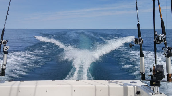 The stern of a sportfishing boat. The view from the rear of a boat you see a long, straight wake.