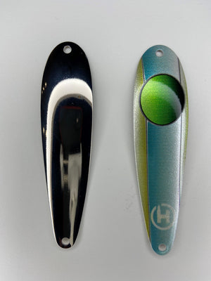 A fishing spoon for lake trout. A teal lake trout fishing lure with olive sides, and a large green circle near the top that fades to black.