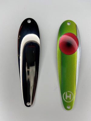 A fishing lure for Musky. A green Musky spoon with one glittery white side, with a large red circle near its top that fades to black at its center.