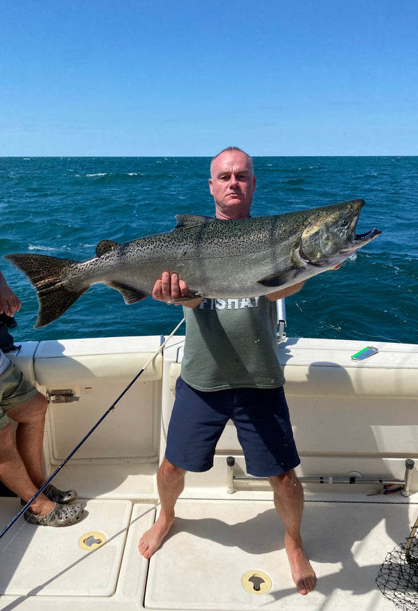 Gary Sherry holding a large Salmon. Sportfishing king salmon catch.