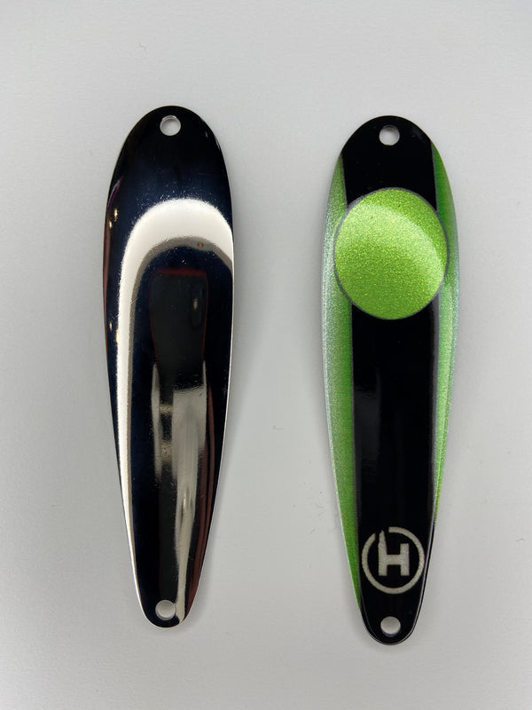 Two fishing lures. Custom fishing spoons for Lake Herring. Fishing spoons for Cisco. Custom, green fishing lure with a black stripe down the center and large, chartreuse oval near the top.