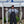 Load image into Gallery viewer, Michael Hiller holding two Salmon and wearing fishing bibs. Man holding salmon caught in Ludington, Michigan.
